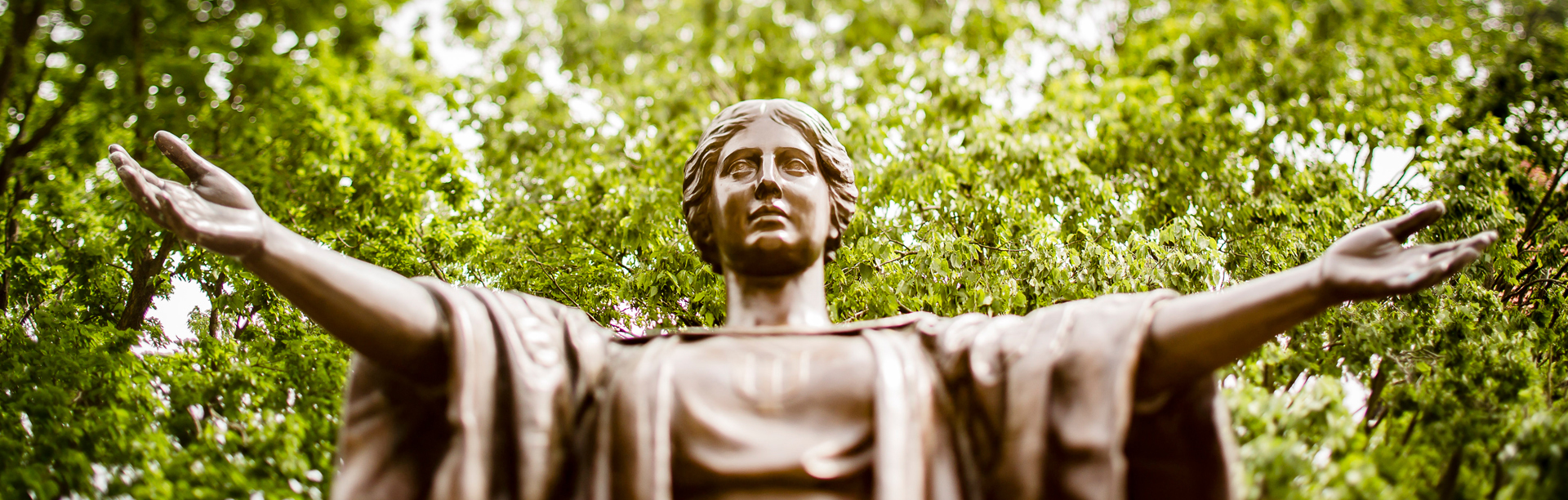 Alma Matter with arms spread wide